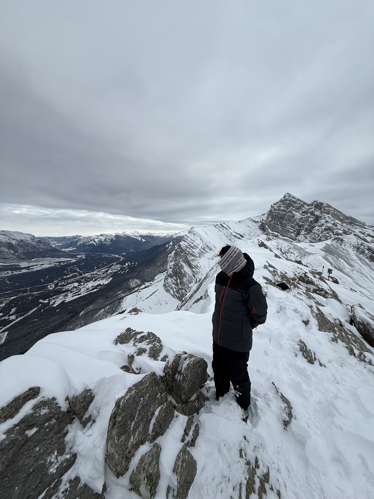 Standing on a snowy mountain summit